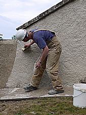 Andrew Newcombe burnishing the lime wash